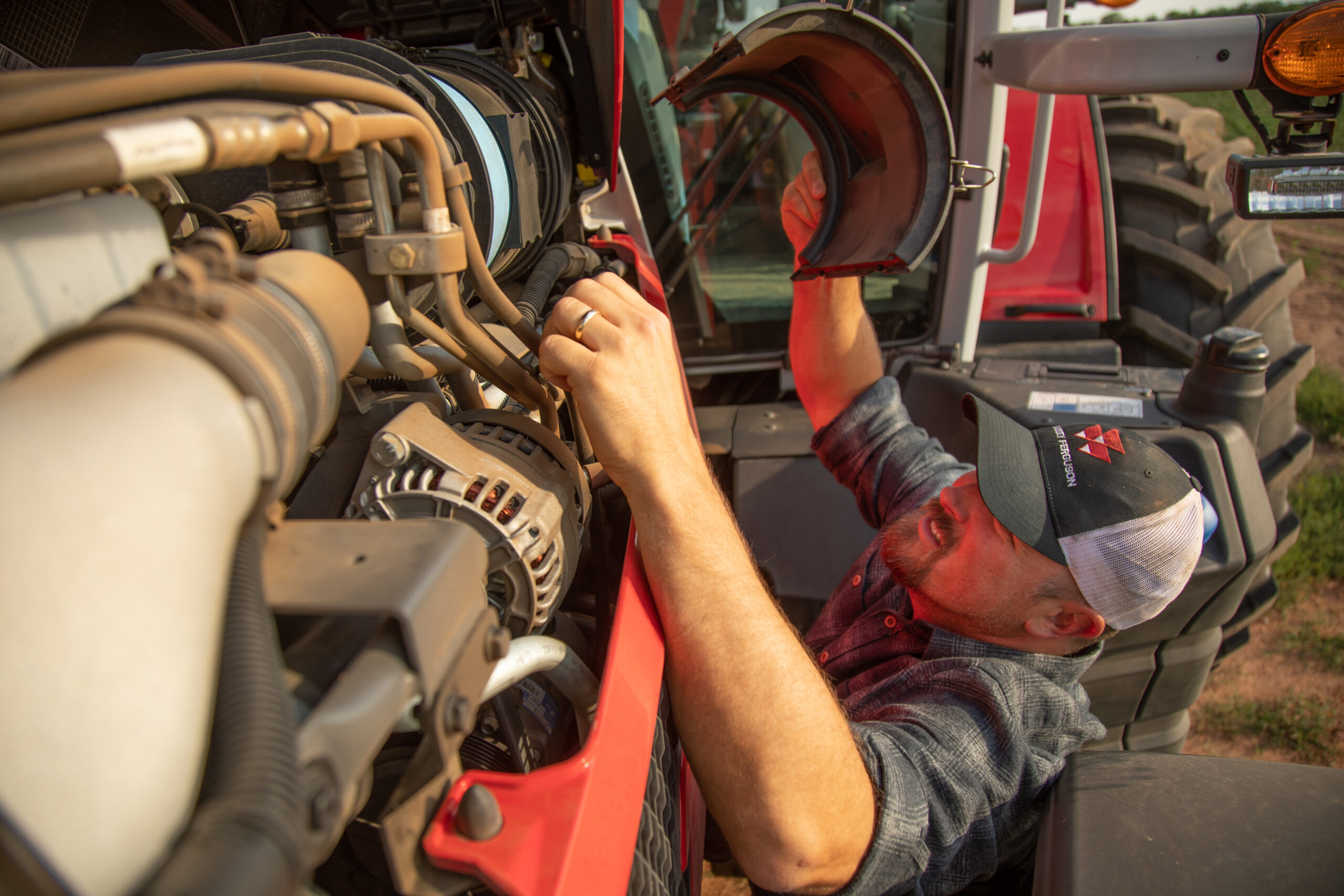 Man servicing Massey Ferguson tractor